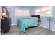 Teal bedroom with wood flooring and large windows at 1535 N Glen Arm Rd, Indianapolis, IN 46214