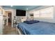 Spacious bedroom with a large TV and blue bedding at 1535 N Glen Arm Rd, Indianapolis, IN 46214
