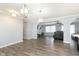 Open dining room with hardwood floors and a view into the living room and kitchen at 1535 N Glen Arm Rd, Indianapolis, IN 46214