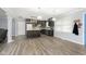 Open concept kitchen boasts an island, dark cabinetry, and stainless steel appliances at 1535 N Glen Arm Rd, Indianapolis, IN 46214