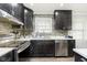 Updated kitchen featuring dark cabinetry and tile backsplash at 1535 N Glen Arm Rd, Indianapolis, IN 46214