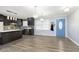Open kitchen with dark cabinets, island, and stainless steel appliances at 1535 N Glen Arm Rd, Indianapolis, IN 46214