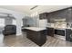 Modern kitchen with island, dark cabinetry, and stainless steel appliances at 1535 N Glen Arm Rd, Indianapolis, IN 46214