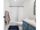 Clean bathroom featuring blue vanity, white subway tile, and a bathtub at 1937 Shiloh Dr, Columbus, IN 47203