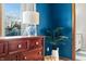 Blue walls and wood dresser with a lamp at 1937 Shiloh Dr, Columbus, IN 47203