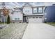 Two-story home with gray siding, brick accents, and a two-car garage at 19971 Edwick Dr, Westfield, IN 46074