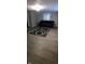 Finished basement with gray flooring and couch at 2914 Collier St, Indianapolis, IN 46241