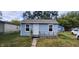 Cute bungalow with light blue siding, new windows, and a ramp for accessibility at 2914 Collier St, Indianapolis, IN 46241