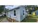 Side view of the house, showcasing its light blue siding and a ramp at 2914 Collier St, Indianapolis, IN 46241