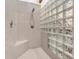 Walk-in shower with glass block wall and tiled walls at 3499 Raspberry Ln, Nineveh, IN 46164