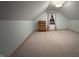 Charming attic bedroom with light walls and carpeting at 410 Terrace Ave, Indianapolis, IN 46225