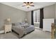 Cozy basement bedroom with striped bedding and large window at 5326 Travis Rd, Greenwood, IN 46143