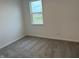 Spacious bedroom with gray carpeting and two windows at 5553 Tart Blvd, Indianapolis, IN 46239