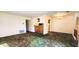 Dining room with kitchen access and vintage carpeting at 8315 Woodall Dr, Indianapolis, IN 46268