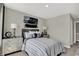 Well-lit bedroom with a striped comforter and a car-themed print at 8913 Lowell St, McCordsville, IN 46055