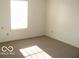 Spacious bedroom with neutral carpeting and large window at 10604 Creekside Woods Dr, Indianapolis, IN 46239