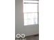 Bright bedroom with large window and neutral walls at 10604 Creekside Woods Dr, Indianapolis, IN 46239
