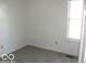Simple bedroom with neutral carpeting and a window at 10604 Creekside Woods Dr, Indianapolis, IN 46239