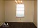 Simple dining room with chandelier and laminate floor at 10604 Creekside Woods Dr, Indianapolis, IN 46239