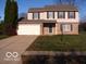 Two-story brick home with attached garage and landscaped lawn at 10604 Creekside Woods Dr, Indianapolis, IN 46239