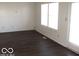 Living room with dark laminate floors and large windows at 10604 Creekside Woods Dr, Indianapolis, IN 46239