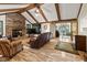 Spacious living room with wood-beamed ceilings, brick fireplace, and ample seating at 10757 Kelly Ct, Indianapolis, IN 46231