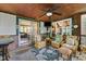 Inviting sunroom with wicker furniture, ceiling fan, and view of the backyard at 10757 Kelly Ct, Indianapolis, IN 46231