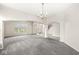 Spacious dining room with gray carpet and chandelier at 13271 Lorenzo Blvd, Carmel, IN 46074