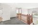 Upstairs hallway with wood railing and carpet at 13271 Lorenzo Blvd, Carmel, IN 46074