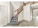 Elegant staircase with wooden railing and gray carpet at 13271 Lorenzo Blvd, Carmel, IN 46074