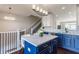 Modern kitchen with blue cabinets and quartz island at 15368 Mystic Rock Dr, Carmel, IN 46033