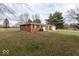 Side view of brick ranch house, showcasing landscaping and yard at 1892 W 1000 S, Pendleton, IN 46064