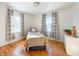 Bright bedroom with hardwood floors, two windows, and a twin bed at 1922 E 5Th St, Anderson, IN 46012