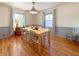 Bright dining room with hardwood floors, light walls and a large table at 1922 E 5Th St, Anderson, IN 46012