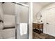 Bathroom with a shower, round mirror, and dark brown vanity at 232 W Wiley St, Greenwood, IN 46142