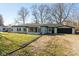 Ranch home with green exterior, sunroom, and attached garage at 3060 S Shortridge Rd, Indianapolis, IN 46239