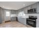 Modern kitchen with gray cabinets and white tile backsplash at 3060 S Shortridge Rd, Indianapolis, IN 46239