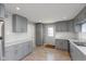 Updated kitchen featuring gray cabinets and tile flooring at 3060 S Shortridge Rd, Indianapolis, IN 46239