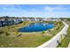 Aerial view of community pond with homes and walking path at 543 Gilder Dr, Carmel, IN 46032