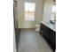 Bathroom with a shower/tub combo, double vanity, and window at 6936 W Briarwood Blvd, New Palestine, IN 46163