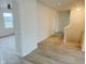 Bright hallway with wood-look floors and access to bedrooms at 6936 W Briarwood Blvd, New Palestine, IN 46163