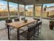 Screened-in porch with wooden table and chairs overlooking the backyard pool at 6936 W Briarwood Blvd, New Palestine, IN 46163