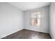 Simple bedroom with gray walls, vinyl flooring, and a window with curtains at 807 Alden Dr, Fortville, IN 46040
