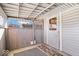 Enclosed porch with gray wood walls and white door, offering extra outdoor space at 807 Alden Dr, Fortville, IN 46040