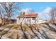 Ranch home with red roof, covered porch, and landscaped yard at 807 Alden Dr, Fortville, IN 46040