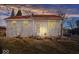 House exterior at dusk with lights on, showcasing curb appeal at 807 Alden Dr, Fortville, IN 46040