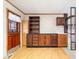 Dark wood cabinets, built-in shelving, and light flooring at 807 Alden Dr, Fortville, IN 46040