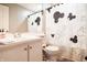 Charming bathroom with Mickey Mouse shower curtain, white vanity, and tiled floor at 8435 Buckingham Dr, Columbus, IN 47201