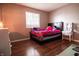 Cozy bedroom featuring a double bed, hardwood floors, and a window at 8435 Buckingham Dr, Columbus, IN 47201