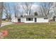 White ranch house with a gray door and landscaping at 9923 N 125 W, Fortville, IN 46040